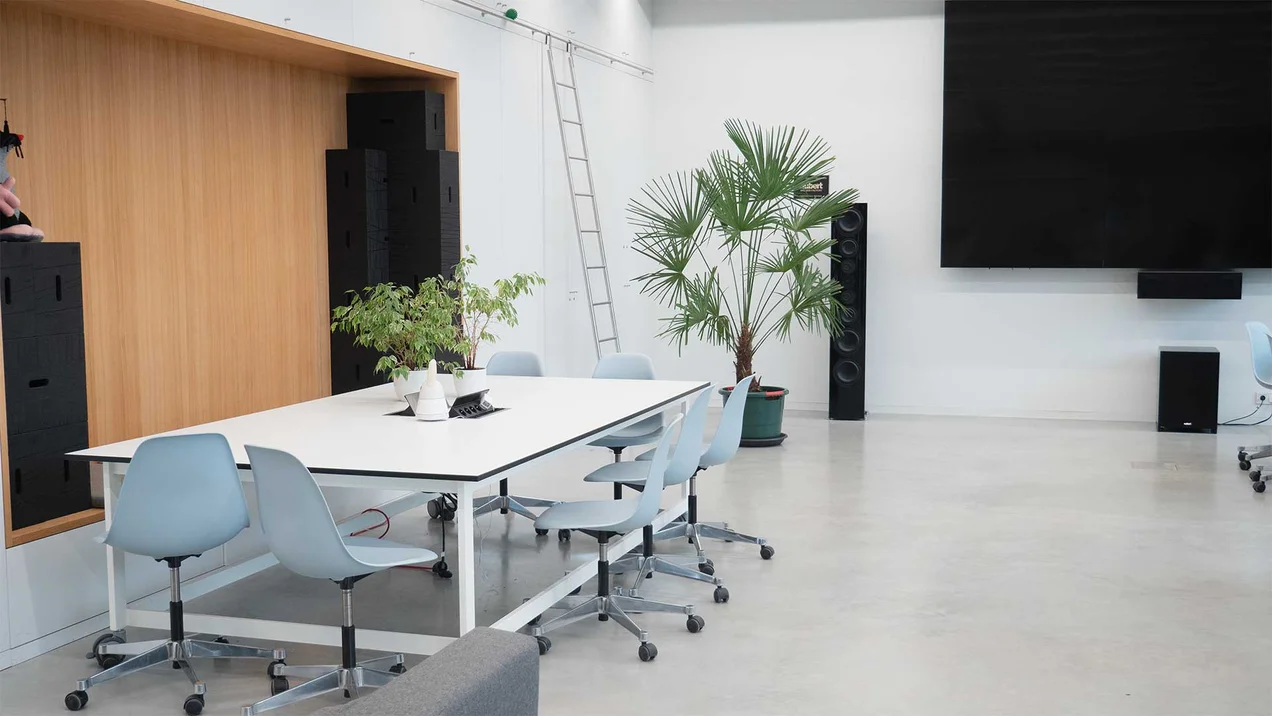 Photo of the Creative Lab with workstations, plants and video wall.