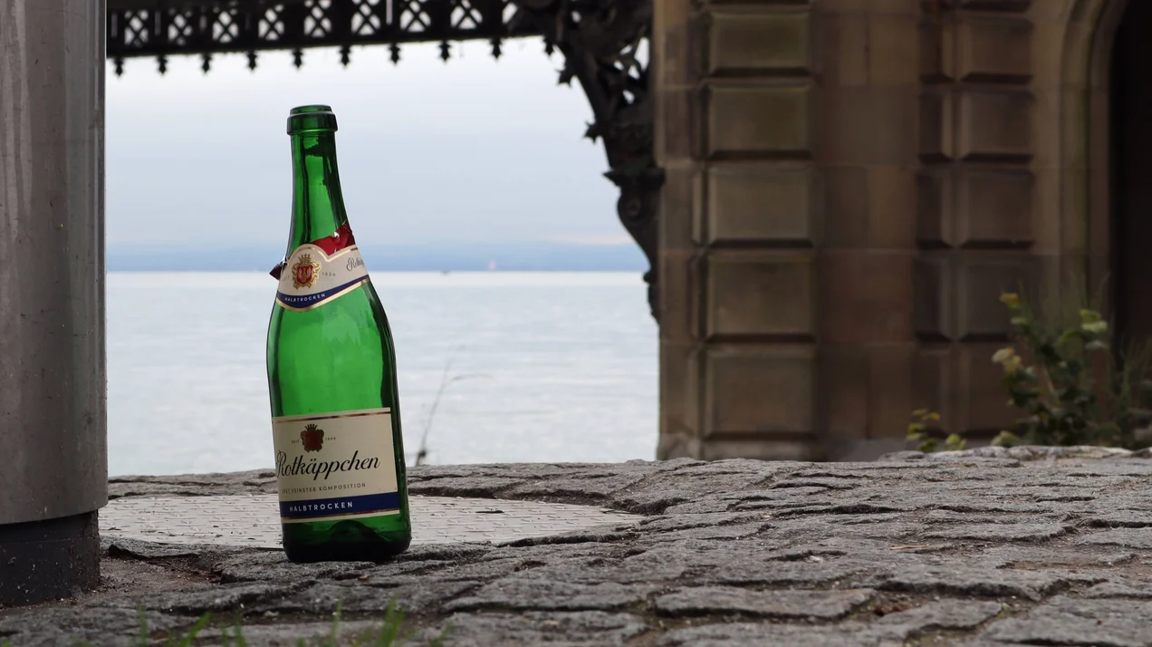 Eine leere Flasche vor einem Torbogen